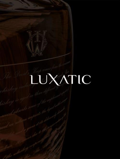 A bottle of premium whiskey and the luxatic logo