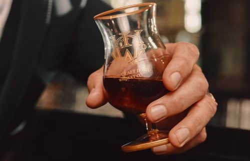 A man holding a finn glass for luxury whiskey