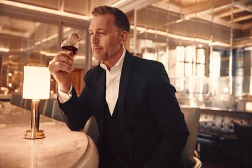 A man holding a glass of luxury whiskey