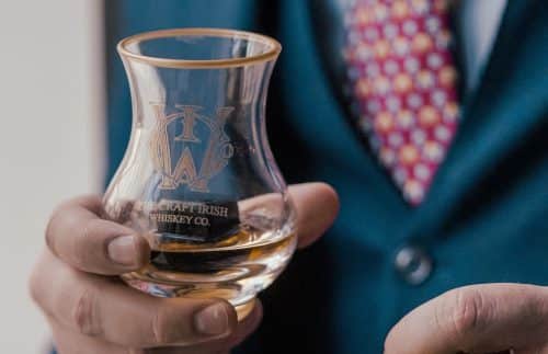 A man holding a glass from The Craft Irish Whiskey Co.