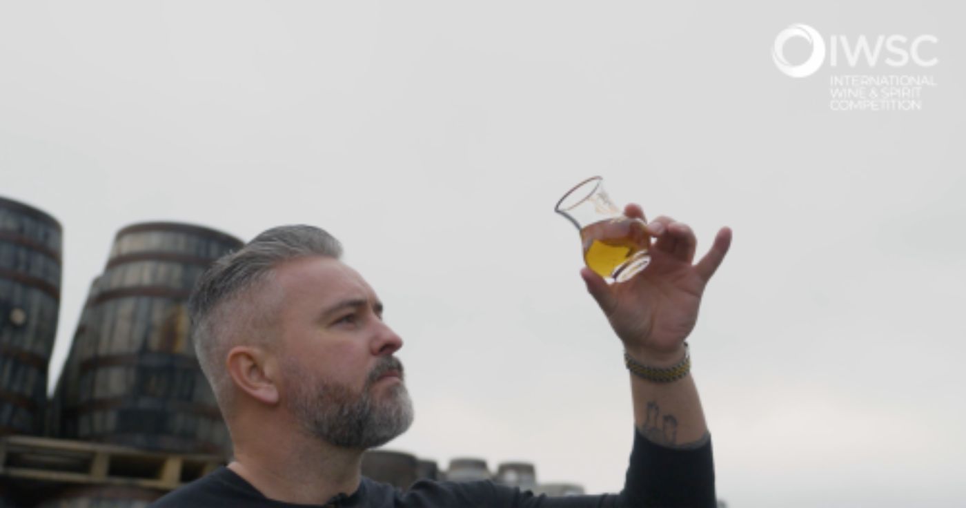 Jay Bradley looking at premium whiskey in a whiskey tasting glass
