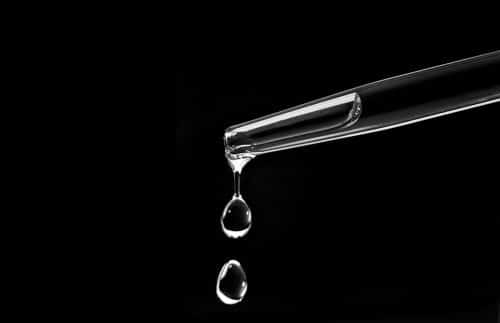 A pipette and two drops of premium irish whiskey