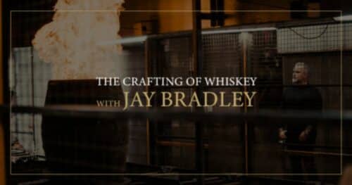 Jay Bradley looking at a whiskey barrel