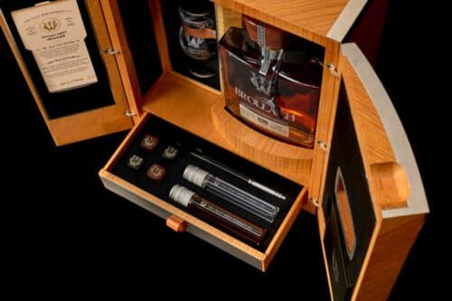 The Brollach double distilled craft irish whiskey in a natural oak box with four obsidian whiskey stones, glassware and Irish spring water