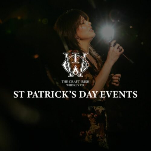 A woman singing at St Patrick's Day and premium whiskey