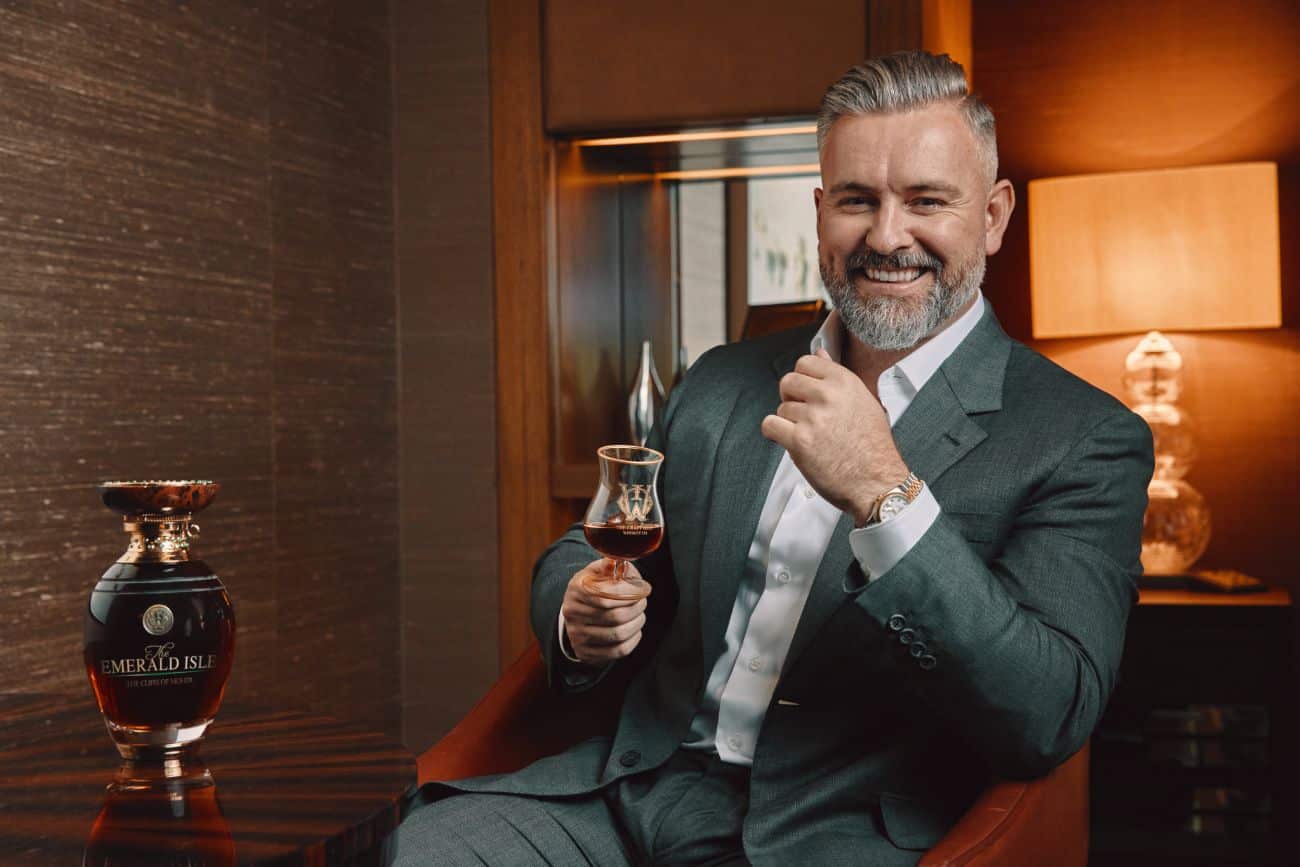 Jay Bradley holding a glass of the most expensive whiskey