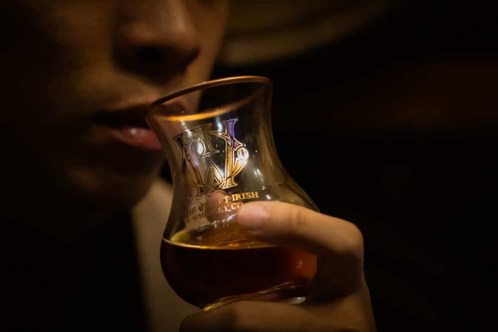 A person drinking artisan whiskey