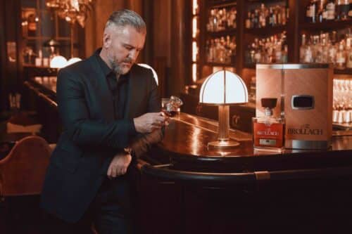 Jay Bradley holding a fine whiskey glass with luxury Irish whiskey