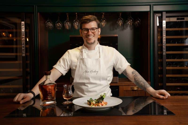 Adam Handling and artisan whiskey bottle of the Taoscán