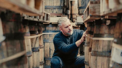 Jay Bradley looking at an Irish whiskey barrel