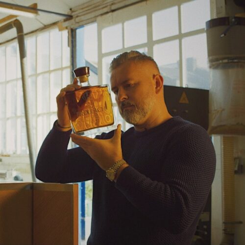 Master Blender Jay Bradley holding a bottle of Ultra Premium Irish whiskey