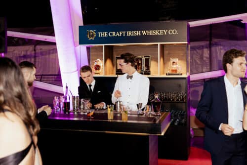 Expensive single malt irish whiskey being served at an event with two bartenders